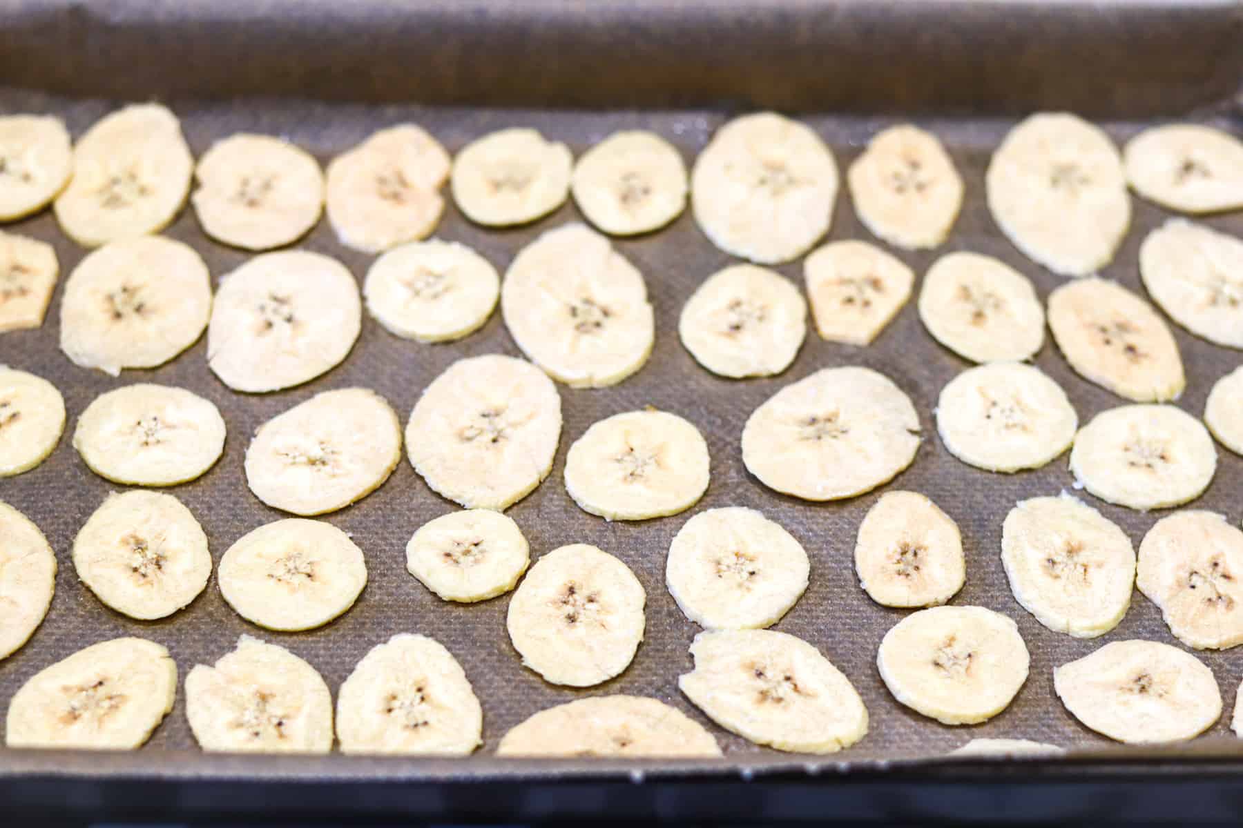 Plantain slices on a baking tray