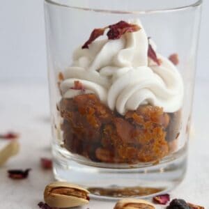These highly indulgent vegan gajar halwa jars are a modern take on the classic Indian dessert gajar halwa or carrot halwa, topped with fresh coconut whipped cream and dry rose petals.