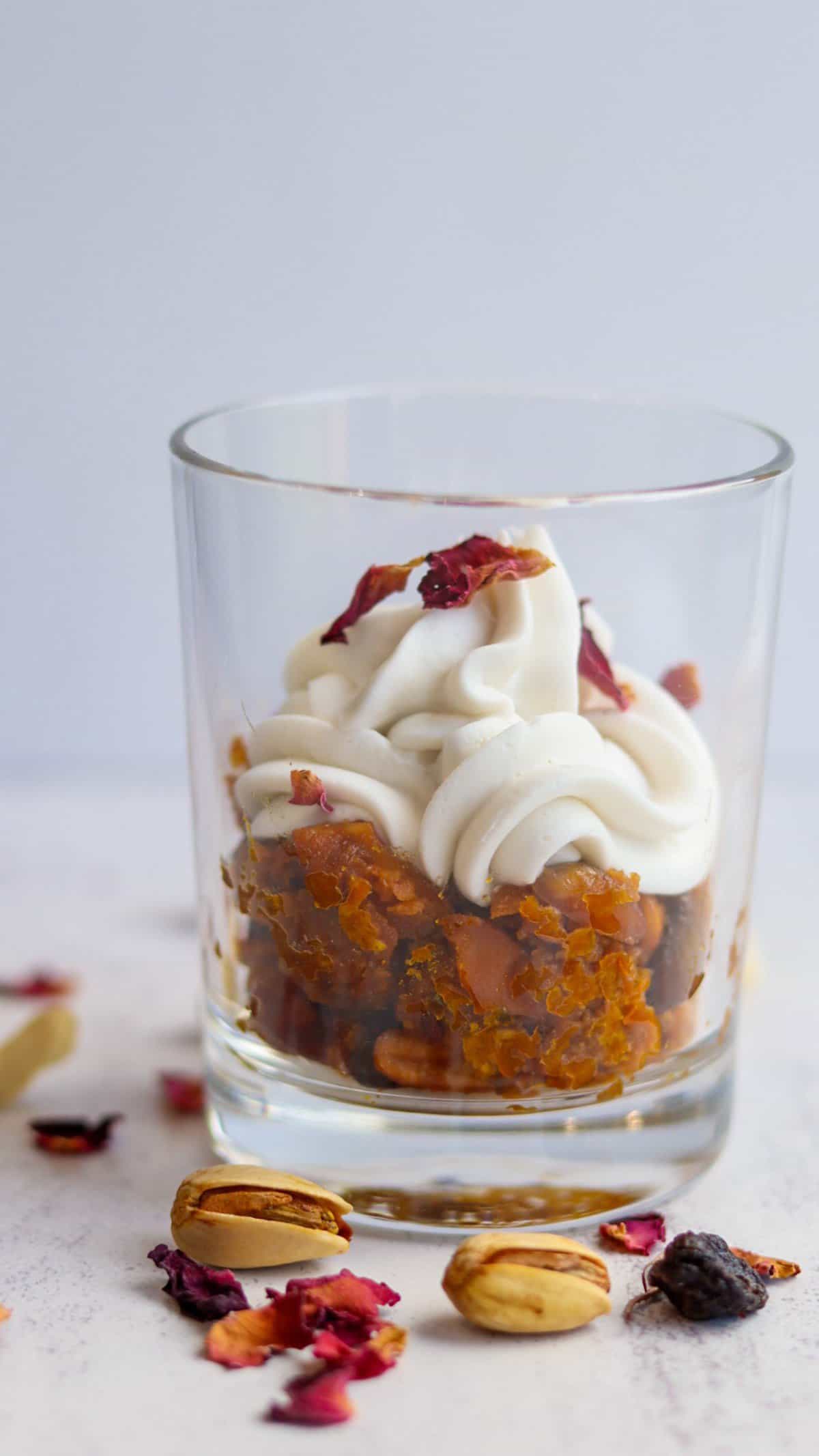 These highly indulgent vegan gajar halwa jars are a modern take on the classic Indian dessert gajar halwa or carrot halwa, topped with fresh coconut whipped cream and dry rose petals. 