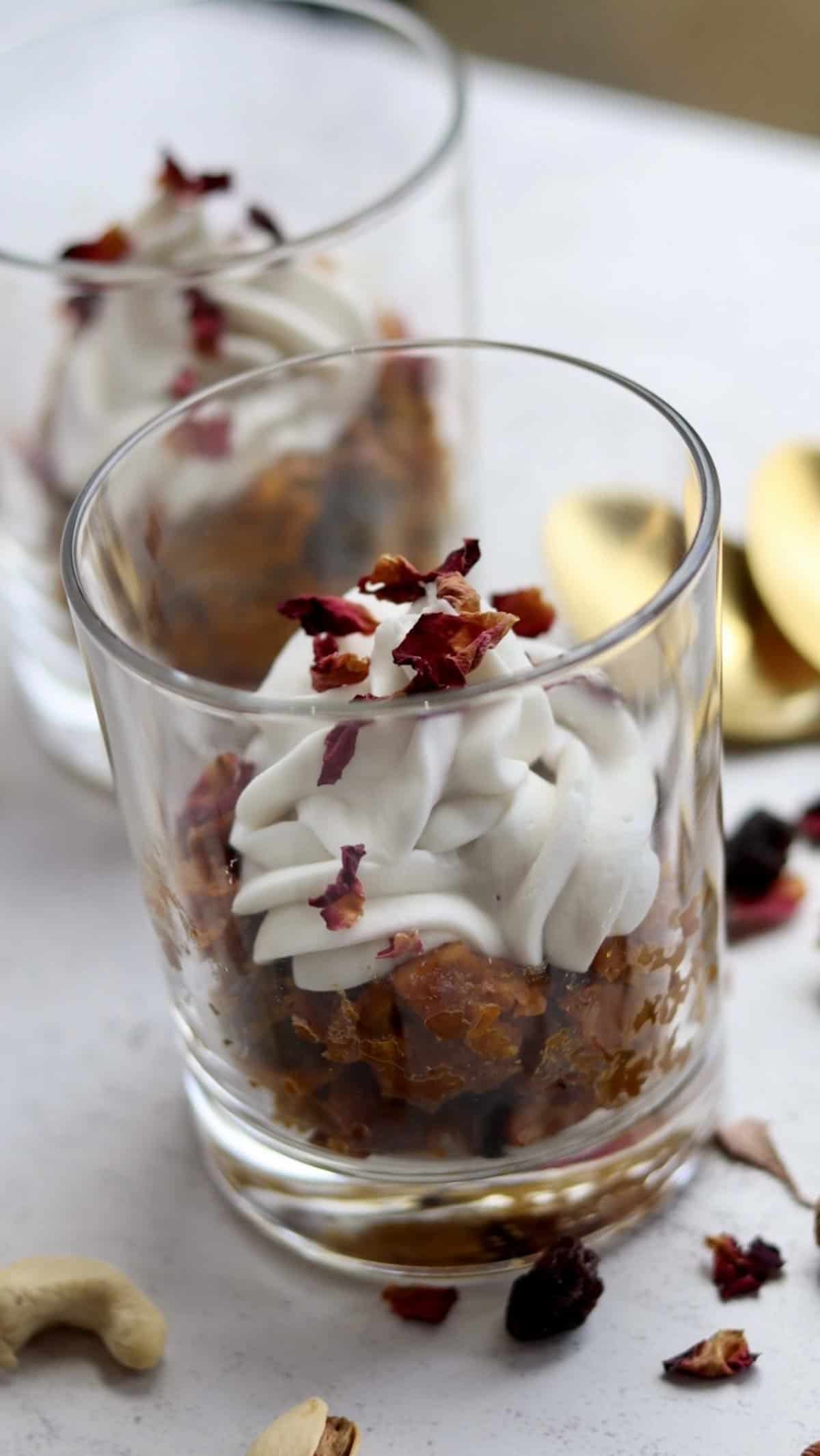 These highly indulgent vegan gajar halwa jars are a modern take on the classic Indian dessert gajar halwa or carrot halwa, topped with fresh coconut whipped cream and dry rose petals. 
