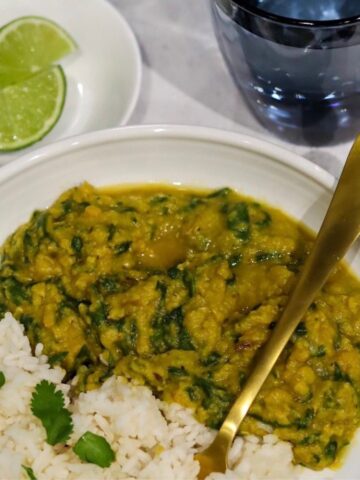 Spinach dal or dal palak in a bowl with rice on the side