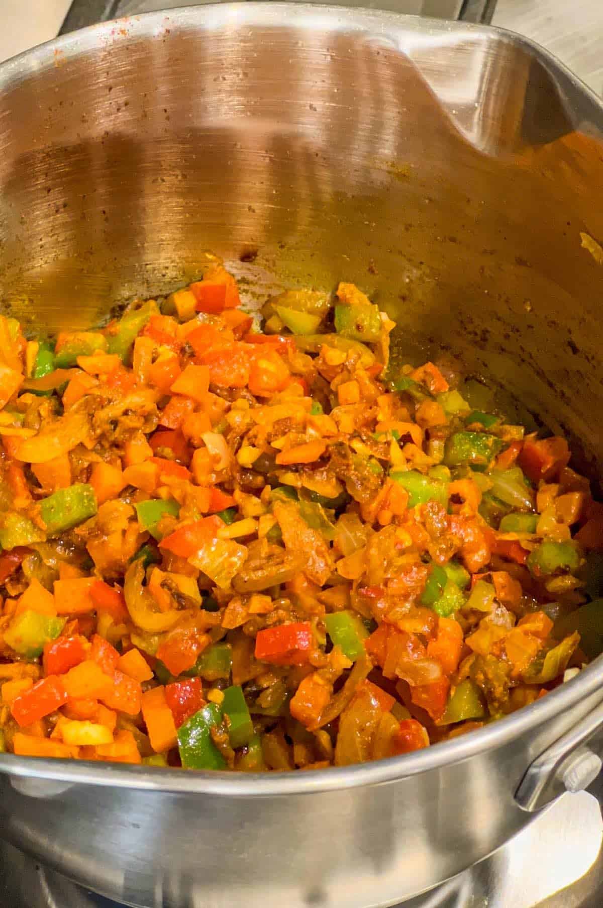 Vegetables cooking in a saucepan for the Nando's spicy rice
